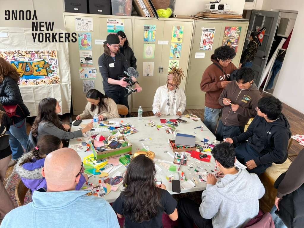 People sitting around a table making art together.