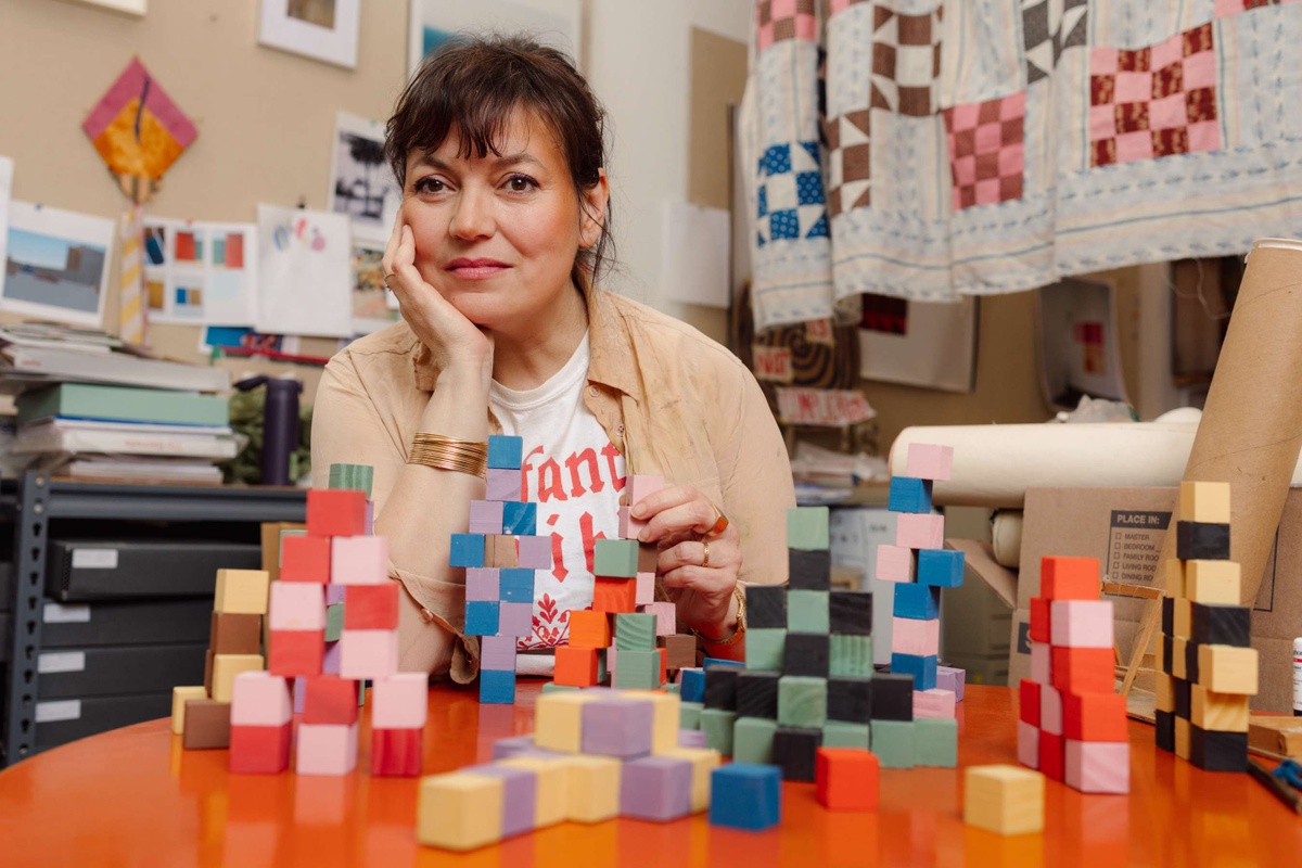 Artist Yto Barrada sits in her studio among colorful blocks